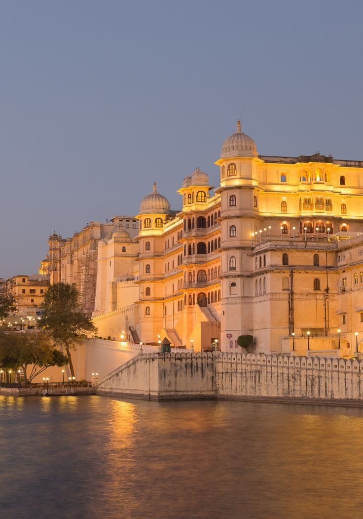 City Palace, Udaipur, lit at dusk over Lake Pichola