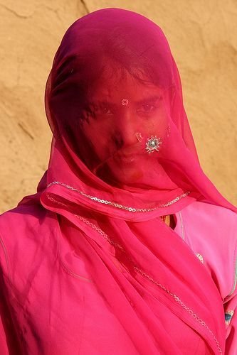A Rajasthani woman veiled in a pink odhni